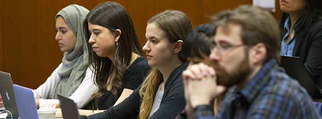 Students sit in a lecture at the College of Law.