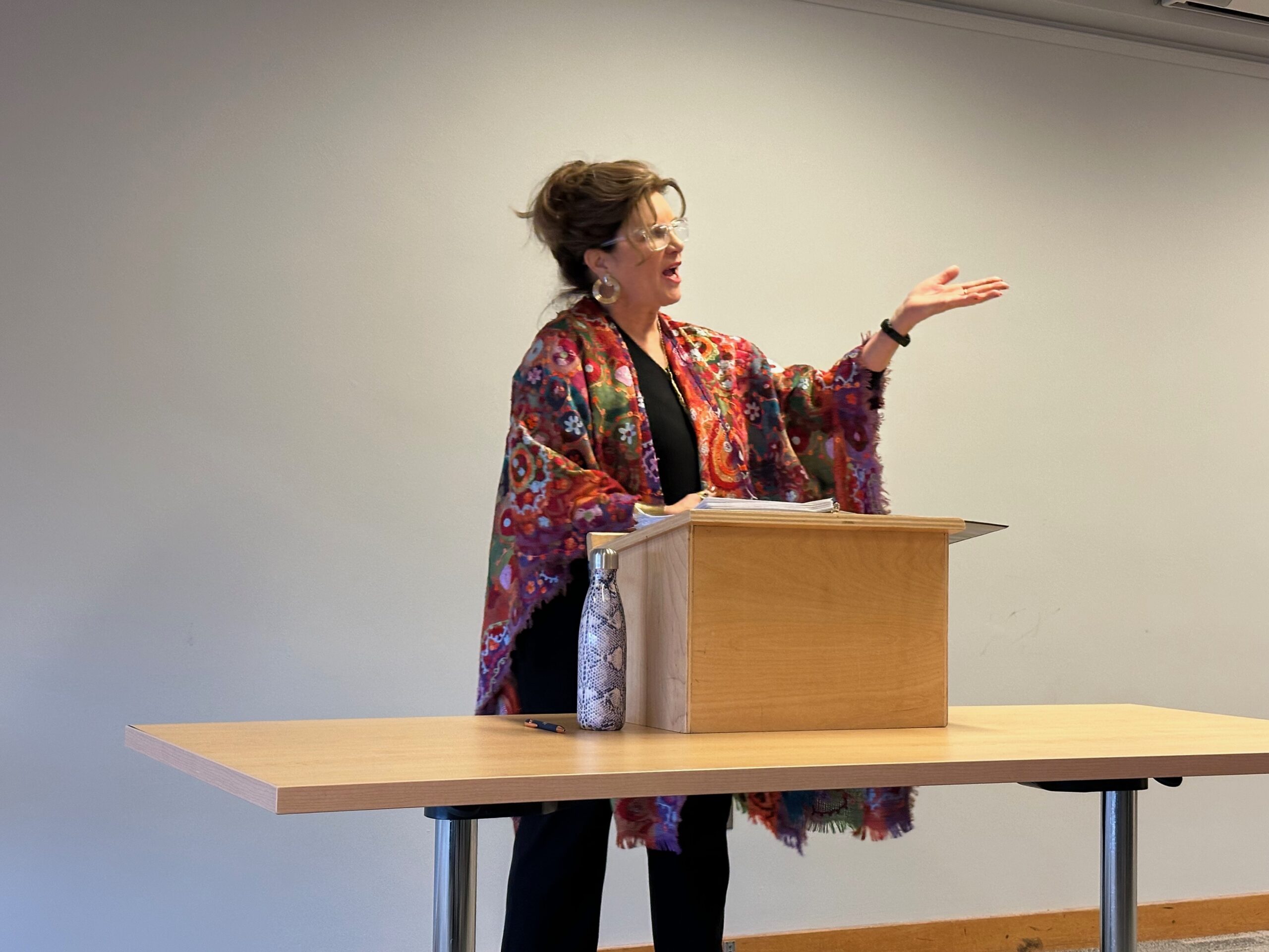 Heidi Hurd stands at a podium and delivers a lecture