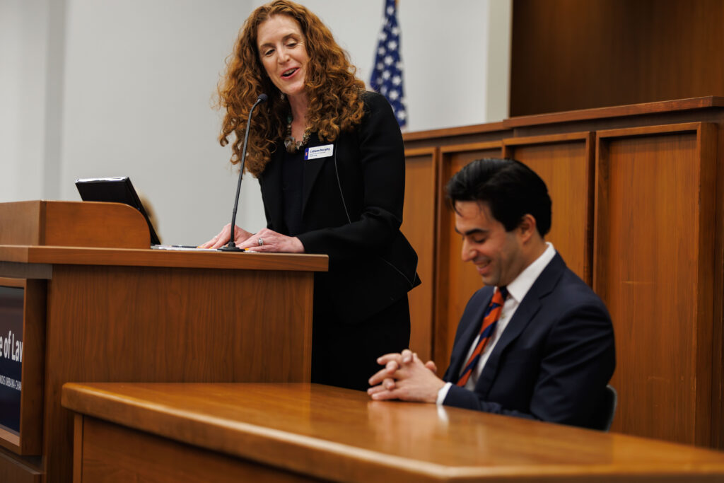 Professor Colleen Murphy gives remarks and shares a laugh with Professor Jake Sherkow.