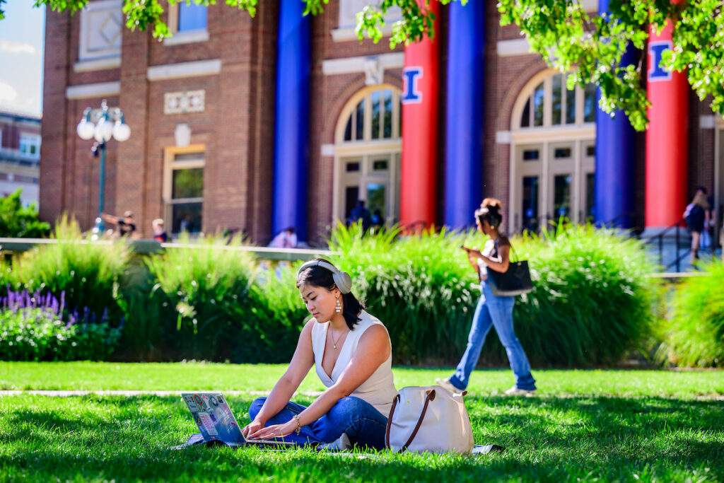 Female student studying on Quad with laptop